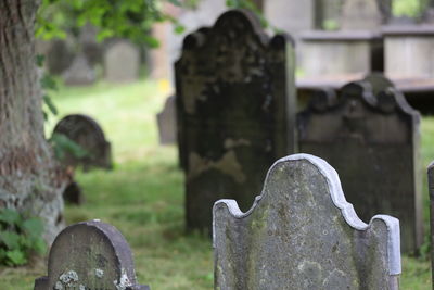 Close-up of graves against stone wall