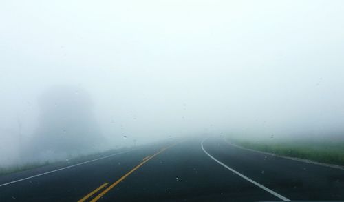 Road passing through foggy weather