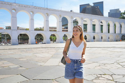 Portrait of young tourist woman visiting lapa in rio de janeiro, brazil