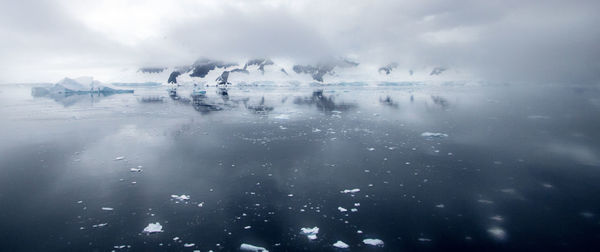 Scenic view of frozen lake against sky