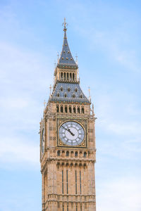 Low angle view of clock tower against sky