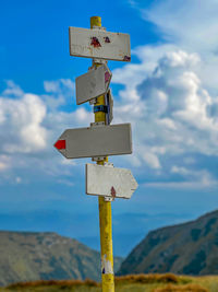 Low angle view of road sign against sky