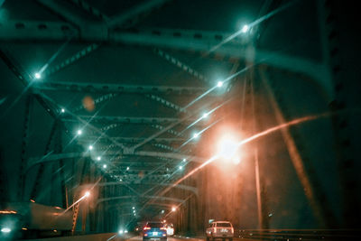 Low angle view of illuminated street at night