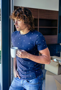 Woman standing by coffee cup