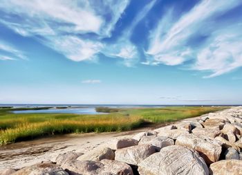 Scenic view of beach against blue sky