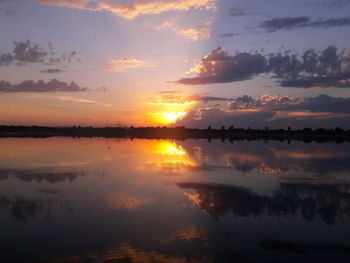 Scenic view of calm lake at sunset