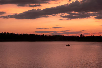 Scenic view of lake against orange sky