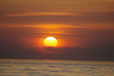 Scenic view of sea against romantic sky at sunset