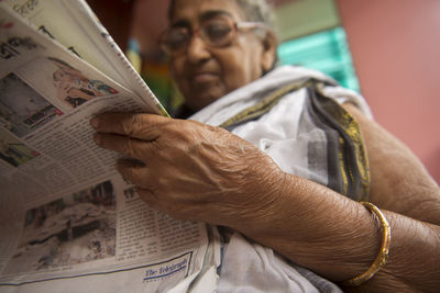 Lady reading the news paper