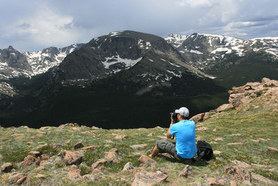 Asian photographer take a picture at hill peak edge of rocky mountain natural park 