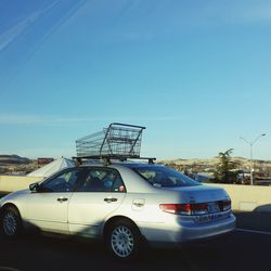 Cars on road against blue sky