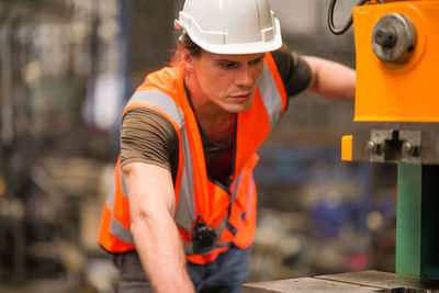 Portrait of male worker standing in the heavy industry manufacturing factory.