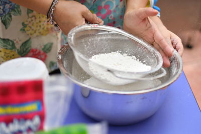 Midsection of woman holding ice cream in bowl