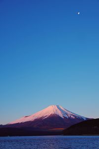 Scenic view of mountains against clear blue sky