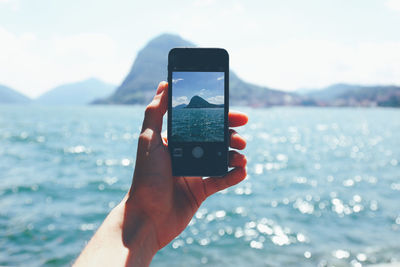 Cropped image of man holding smart phone