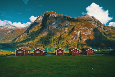 Houses by mountains against sky