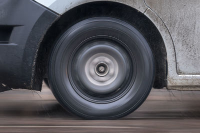 Car tire on sanded winter road