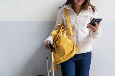 Midsection of woman using mobile phone
