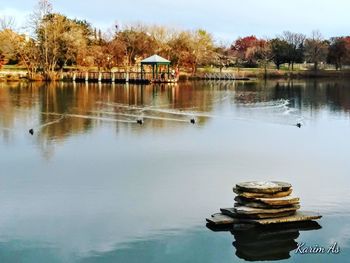 Scenic view of lake by trees against sky