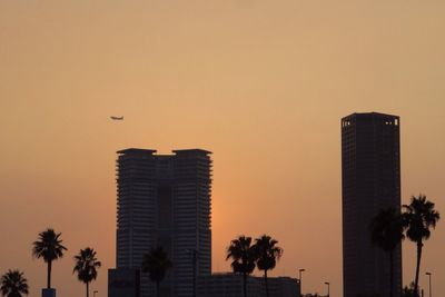 Low angle view of buildings against sky at sunset