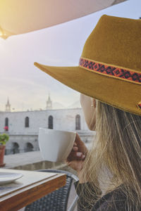 Tourist woman drinking coffee on vacation in street, arequipa, peru. selective focus