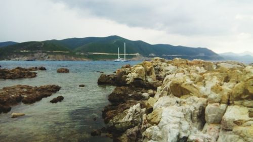 Rocks on beach against sky