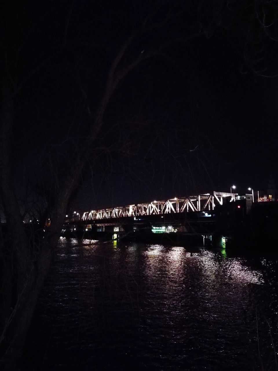 ILLUMINATED PIER AGAINST SKY AT NIGHT