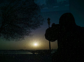 Silhouette of man against sky at night
