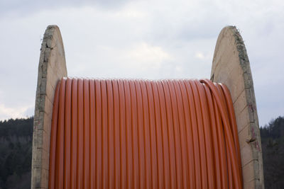 Close-up of metal structure on beach against sky