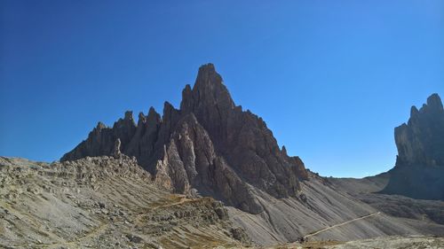 Scenic view of mountains against clear blue sky