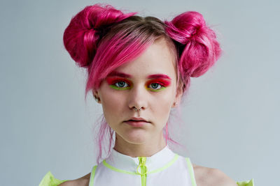 Close-up of young woman against white background