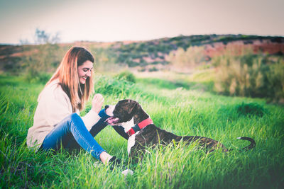 Woman with dog on field