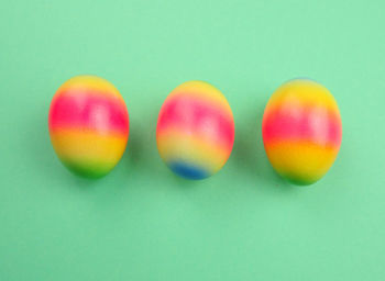 Close-up of multi colored candies against green background