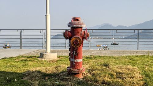 Fire hydrant on field against sky