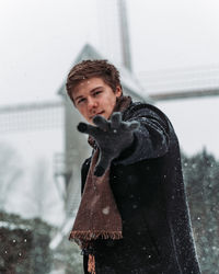 Portrait of woman standing in snow