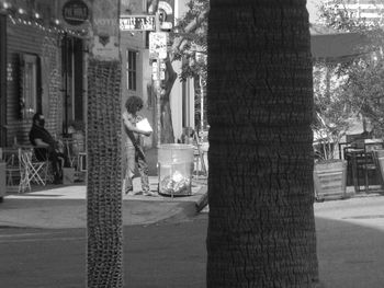 Man standing on street in city