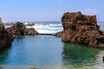  panoramic view of pool rocks against the sky