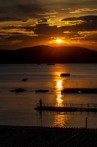 Scenic view of sea against orange sky