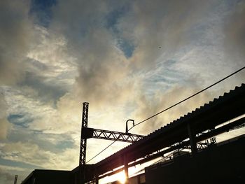 Low angle view of silhouette bridge against sky