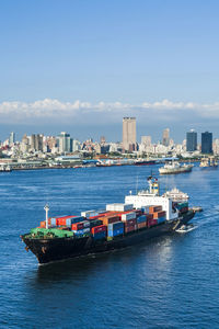 The container ship sailing into the port of kaohsiung, taiwan.