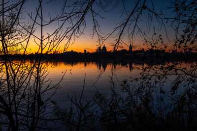 Scenic view of lake against romantic sky at sunset