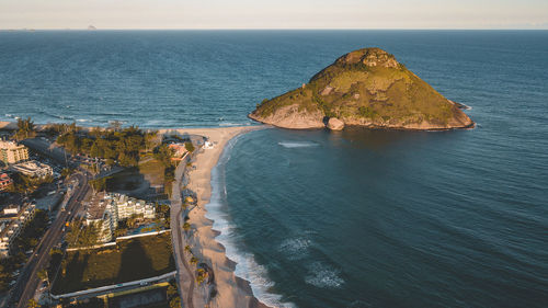 High angle view of rocks on sea shore against sky