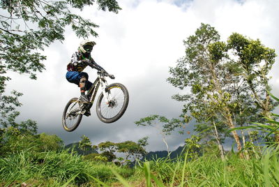 Man riding motorcycle against sky