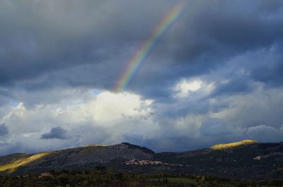 Rainbow over mountain against sky