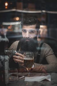 Portrait of young man drinking glass