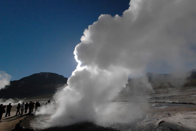 Panoramic view of people on mountain against sky