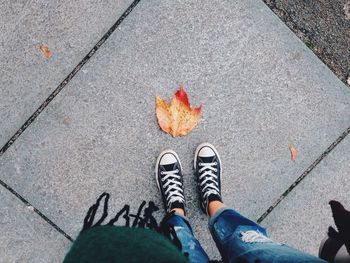 Low section of person standing on road