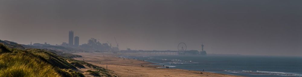 Panoramic view of sea and buildings against sky