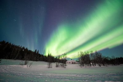 Scenic view of snowy landscape against sky at night