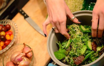 Cropped hands preparing salad